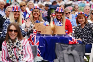 Members of the public watch the coronation of King Charles III and Queen Camilla on a big screen on the grounds of Hillsborough Castle, near Belfast. Picture date: Saturday May 6, 2023. (Photo by Brian Lawless/PA Images via Getty Images)