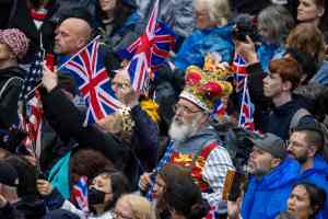 Members of the public walk up The Mall following the procession after the coronations of Britain's King Charles III and Britain's Queen Camilla in London on May 6, 2023. - The set-piece coronation is the first in Britain in 70 years, and only the second in history to be televised. Charles will be the 40th reigning monarch to be crowned at the central London church since King William I in 1066. Outside the UK, he is also king of 14 other Commonwealth countries, including Australia, Canada and New Zealand. Camilla, his second wife, will be crowned queen alongside him, and be known as Queen Camilla after the ceremony. (Photo by Adam Gerrard / POOL / AFP) (Photo by ADAM GERRARD/POOL/AFP via Getty Images)