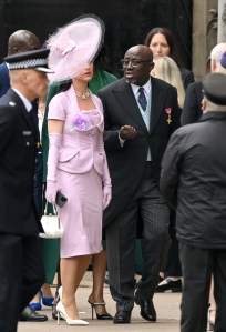 LONDON, ENGLAND - MAY 06: Katy Perry and Edward Enninful arrive at Westminster Abbey for the Coronation of King Charles III and Queen Camilla on May 06, 2023 in London, England. The Coronation of Charles III and his wife, Camilla, as King and Queen of the United Kingdom of Great Britain and Northern Ireland, and the other Commonwealth realms takes place at Westminster Abbey today. Charles acceded to the throne on 8 September 2022, upon the death of his mother, Elizabeth II. (Photo by Karwai Tang/WireImage)