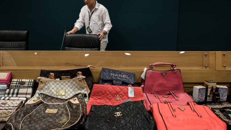 Counterfeit luxury goods are displayed during a press conference following a record seizure at the customs headquarters in Hong Kong in 2015.