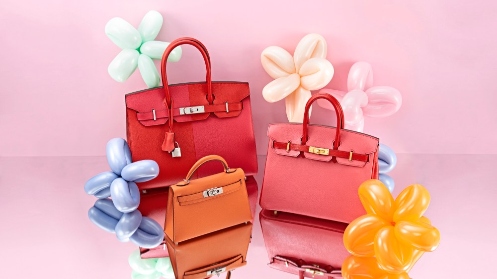 Red, pink and orange Hermès Birkins surrounded by balloon flowers for the Rebag, Christie's "Handbags Online: The New York Edit."