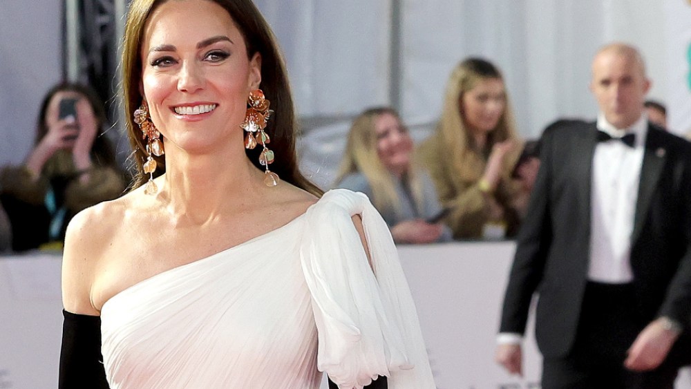 At the BAFTA Awards, Kate re-wore a white Alexander McQueen dress, the left shoulder of which had been altered, black gloves, gold Aquazzura pumps, and a Jimmy Choo clutch.