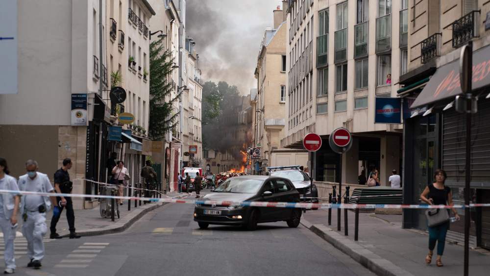 Smoke billows from rubbles of a building at Place Alphonse-Laveran in the 5th arrondissement of Paris, on June 21, 2023. A major fire of unknown origin broke out on June 21, 2023 in a building in central Paris, part of which collapsed, injuring at least one person, according to sources and AFP images. (Photo by ABDULMONAM EASSA / AFP) (Photo by ABDULMONAM EASSA/AFP via Getty Images)