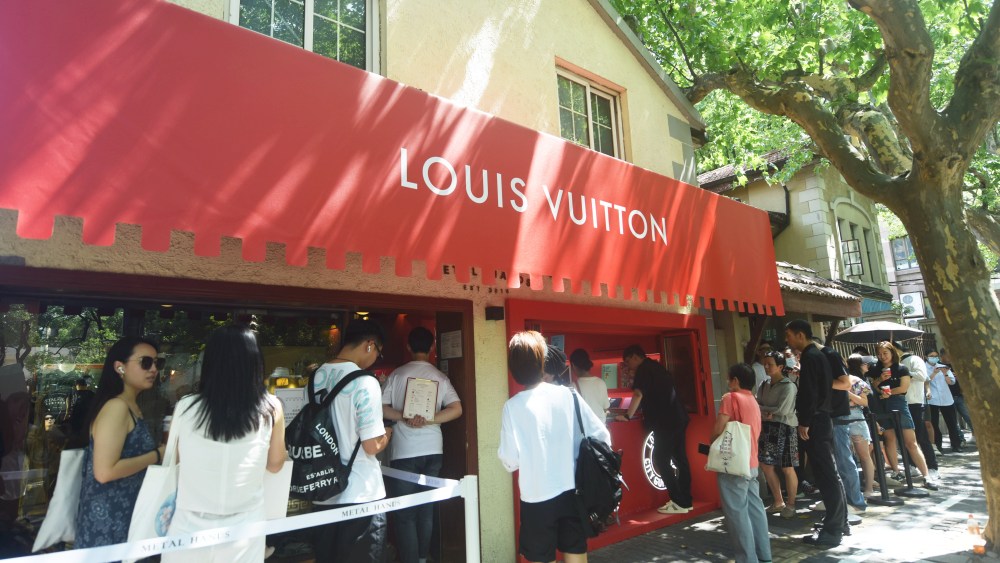 People line up for a Louis Vuitton pop-up cafe and bookstore in Shanghai. Retail sales of catering was among the categories that experienced faster growth in June.