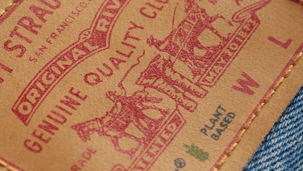 A close-up shot of a plant-based Mirum label for Levi's featuring a green leaf icon.