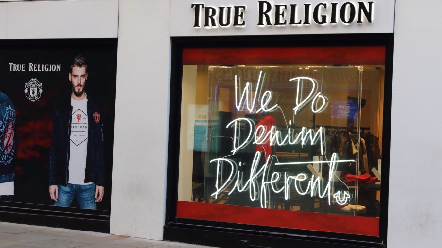 True Religion brand logo seen in Carnaby Street in London, UK.