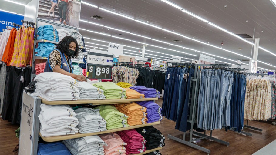A Walmart associate tidies a clothing display in Florida.