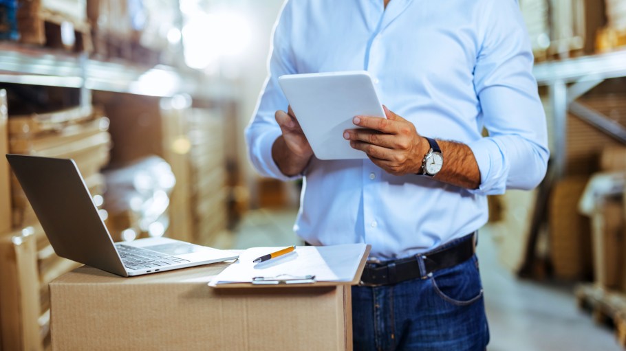 Man using a digital tablet while working in a warehouse