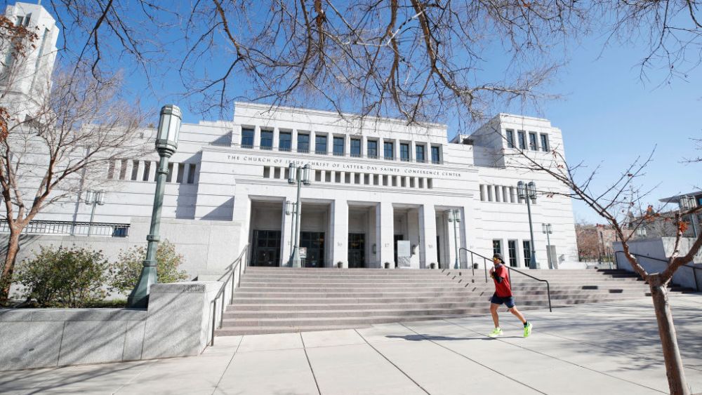 SALT LAKE CITY, UT - APRIL 04: A man runs past the grounds of the Conference Center that sit empty for the 190th Annual General Conference of the Church of Jesus Christ of Latter-Day Saints on April 4, 2020 in Salt Lake City, Utah. The Mormon worldwide two-day conference normally draws 20,000 attendees per session, but due to the COVID-19 virus the conference is being broadcast online only. (Photo by George Frey/Getty Images)