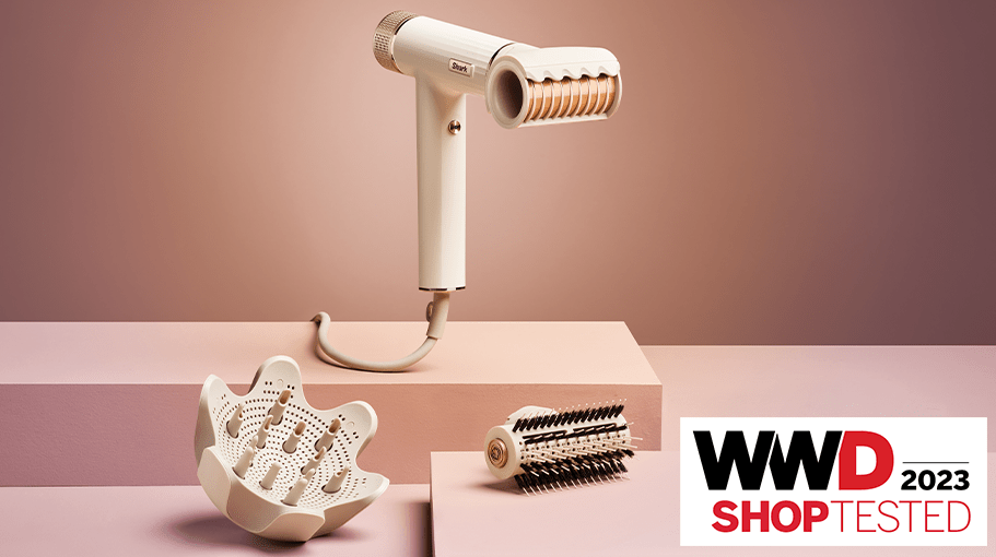 hair dryer with attachments on a pink and brown background