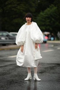 COPENHAGEN, DENMARK - AUGUST 07: A guest wears a white oversized puffy long sleeves / puffy midi dress, white tights, white shiny leather block heels ankle boots , outside Saks Potts, during the Copenhagen Fashion Week Spring/Summer 2024 on August 07, 2023 in Copenhagen, Denmark. (Photo by Edward Berthelot/Getty Images)