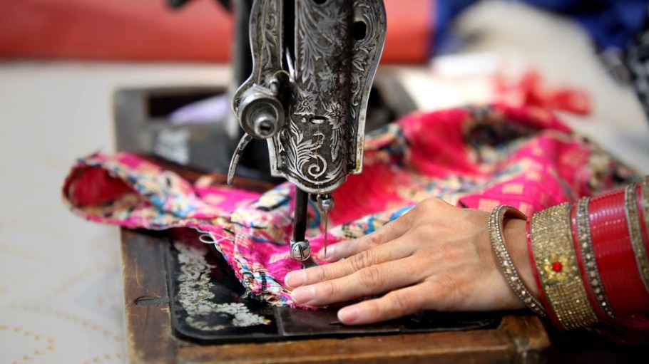 Woman sewing clothing at home.