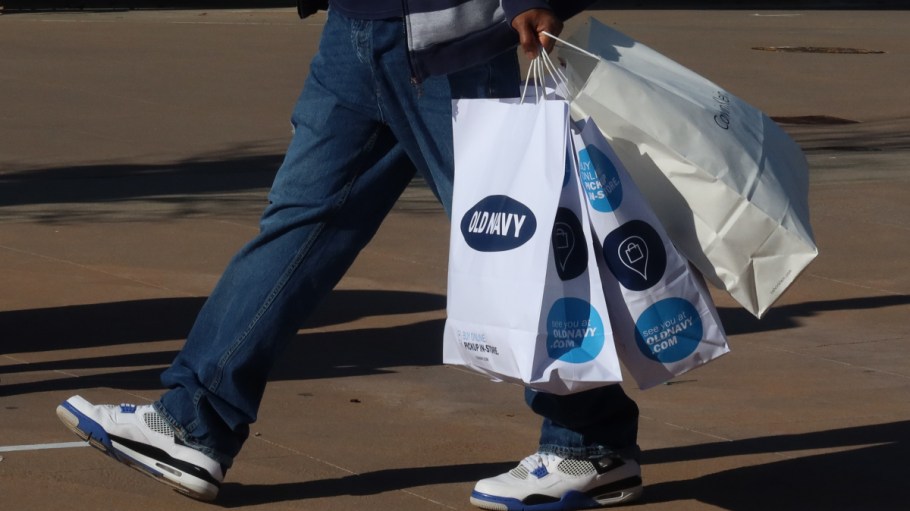 A shopper holding an Old Navy bag at Woodbury Commons.