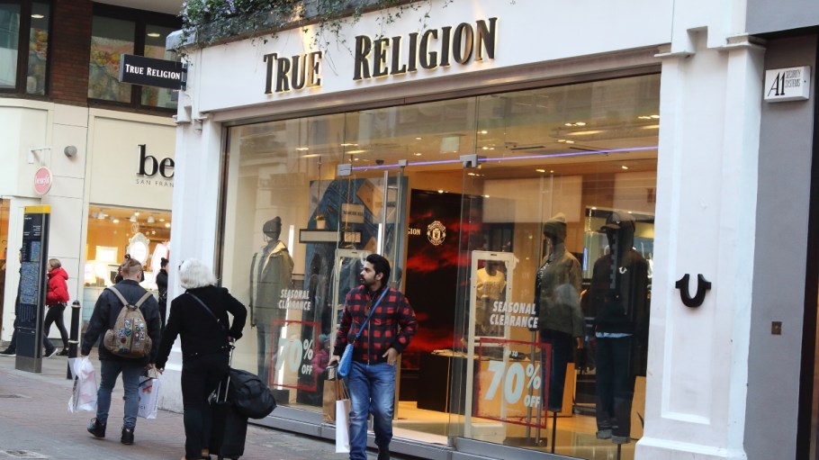 True Religion brand logo seen in Carnaby Street in London, UK.