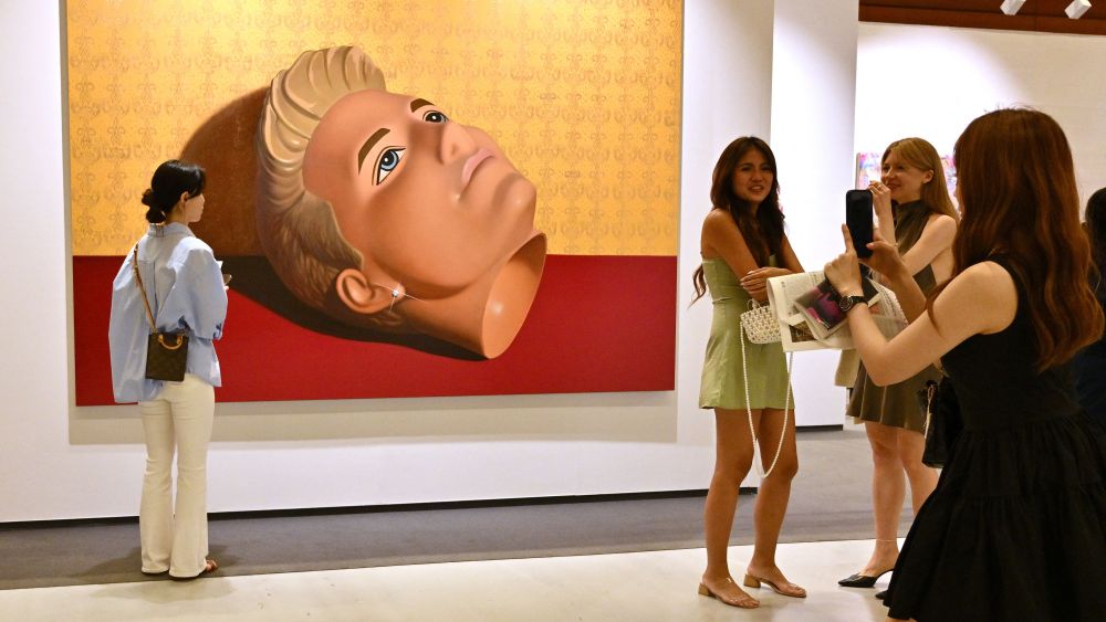 Visitors look at an artwork named "Ken, 2023" by artist Sun Yitian during the Frieze Seoul 2023 art fair in Seoul on September 6, 2023.