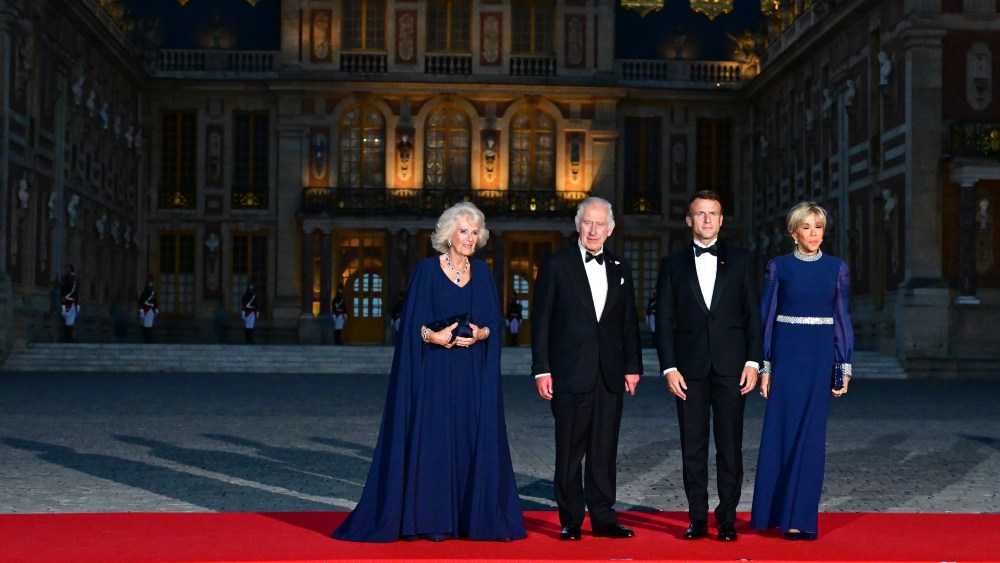 VERSAILLES, FRANCE - SEPTEMBER 20: Queen Camilla and King Charles III are welcomed by French President Emmanuel Macron and Brigitte Macron prior to a state dinner at the Chateau de Versailles on September 20, 2023. The King and The Queen's first state visit to France will take place in Paris, Versailles and Bordeaux from Wednesday 20th to Friday 23rd 2023. The visit had been initially scheduled for March 26th - 29th but had to be postponed due to mass strikes and protests. (Photo by Christian Liewig - Corbis/Corbis via Getty Images)