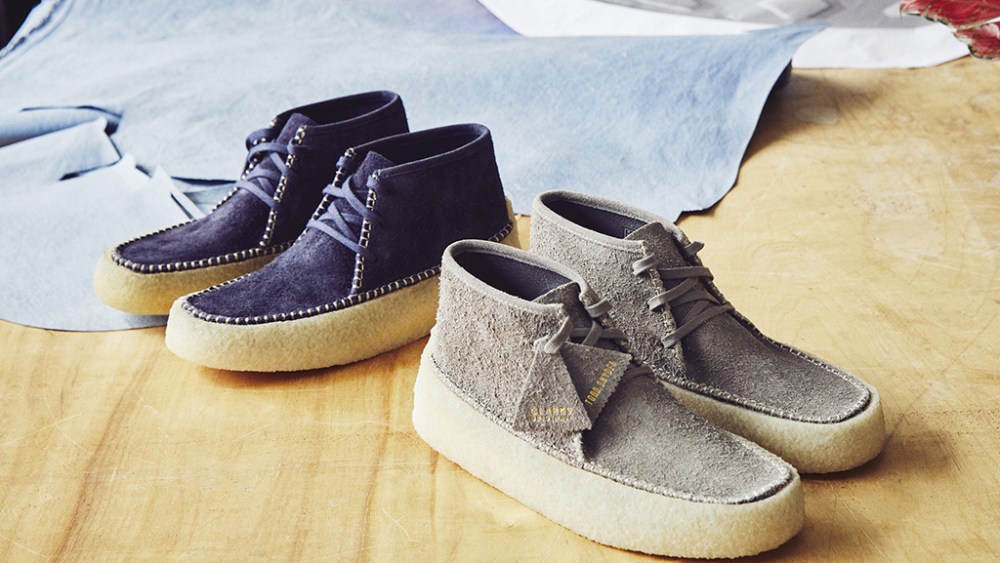The Todd Snyder x Clarks Originals Caravan Boots in navy and grey colorways.