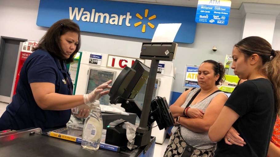 A cashier rings up purchases for shoppers at a Walmart store in Richmond, Calif.
