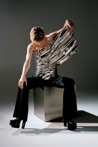 Egon Lab calfskin, resin and metalization bust and wool pants; Rick Owens leather-flared platform boots; Sivan’s own jewelry.
