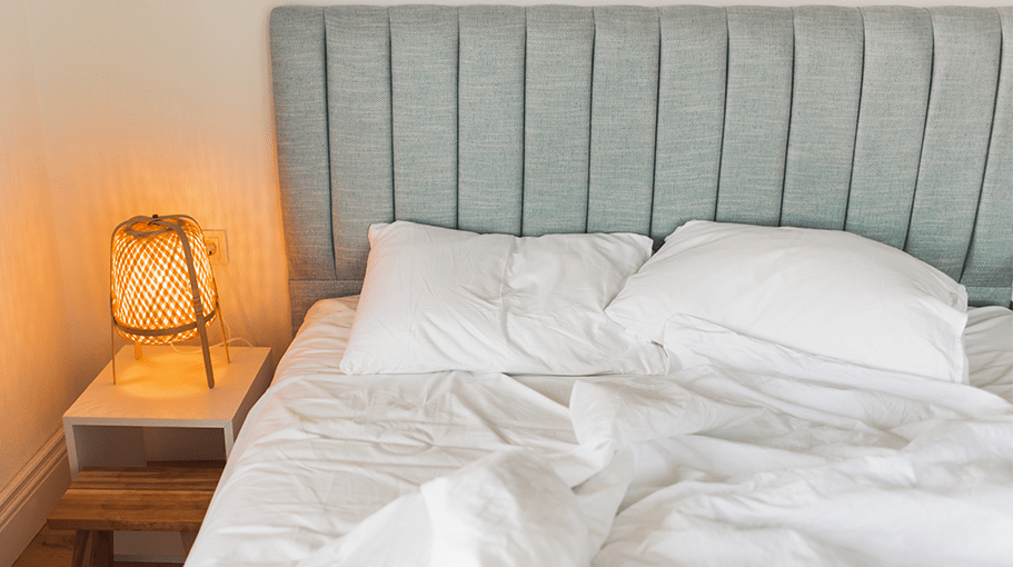 Unmade bed. Bedroom without people. Background with room for copy space. Classic hotel room.