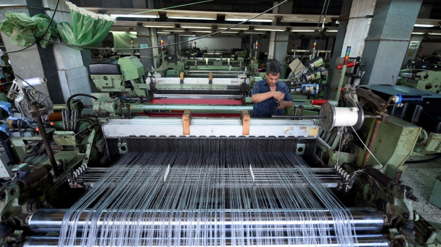 A picture taken on July 29, 2018 shows a worker preparing a threads on a machine at the Marie Louis textile clothing and textile factory in the 10th of Ramadan city, about 60 kms north of Cairo. Egypt received $101 million in new textile investments in October 2023.