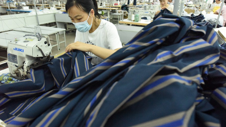 A worker works on an assembly line to produce garments for export orders in Lianyungang, East China's Jiangsu province, June 27, 2023.