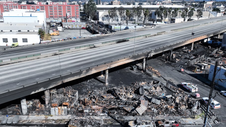 Aerial views of the 10 Freeway in Los Angeles on Sunday, a day after a large pallet fire burned below, shutting the freeway to traffic.