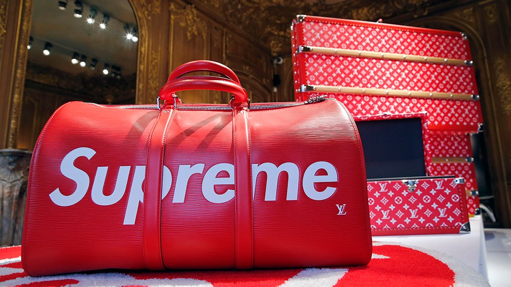 PARIS, FRANCE - MAY 14:  A travel bag entitled "Keepall" by Louis Vuitton x Supreme is displayed during the exhibition "The Rise of Supreme / 30 years of American urban culture" at  Artcurial auction house on May 14 2018 in Paris, France. The Artcurial House will auction off a unique and pioneering retrospective that traces three decades of urban culture in the United States, through the prism of works of art and the inevitable destiny of clothing and accessories streetwear fashion of the American brand Supreme. The auction will take place on May 16, 2018.  (Photo by Chesnot/Getty Images)
