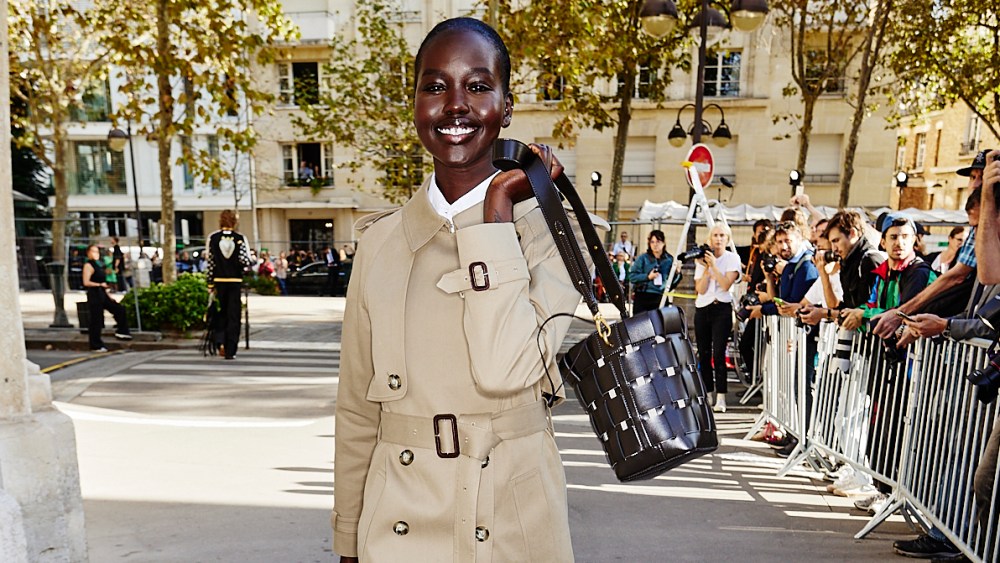 A model at Stella McCartney's spring 2024 show carrying a bag made from upcycled grape waste.