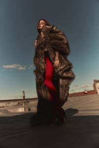 Coperni faux fur wrap coat and shoes; Falke tights; Cartier High Jewelry necklace in 18-karat white gold with diamonds; Cartier Clash de Cartier bracelet and Ecrou de Cartier bracelet in 18-karat white gold.