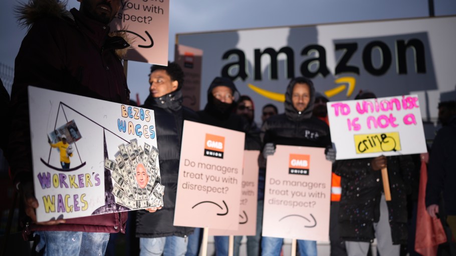 Amazon workers hold GMB union placards on the picket line as they hold a strike outside the Amazon fulfillment center on January 25, 2023 in Coventry, England.