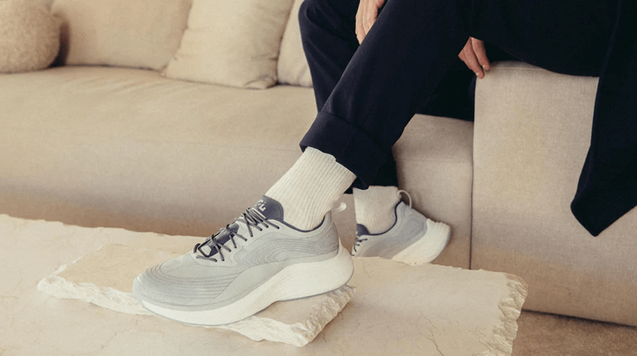 Person wearing wellness gift sneakers on a couch