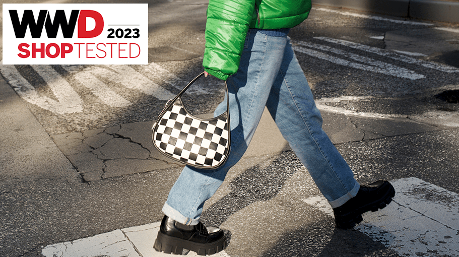 WWD Shop editor carries a checkered black and white shoulder bag