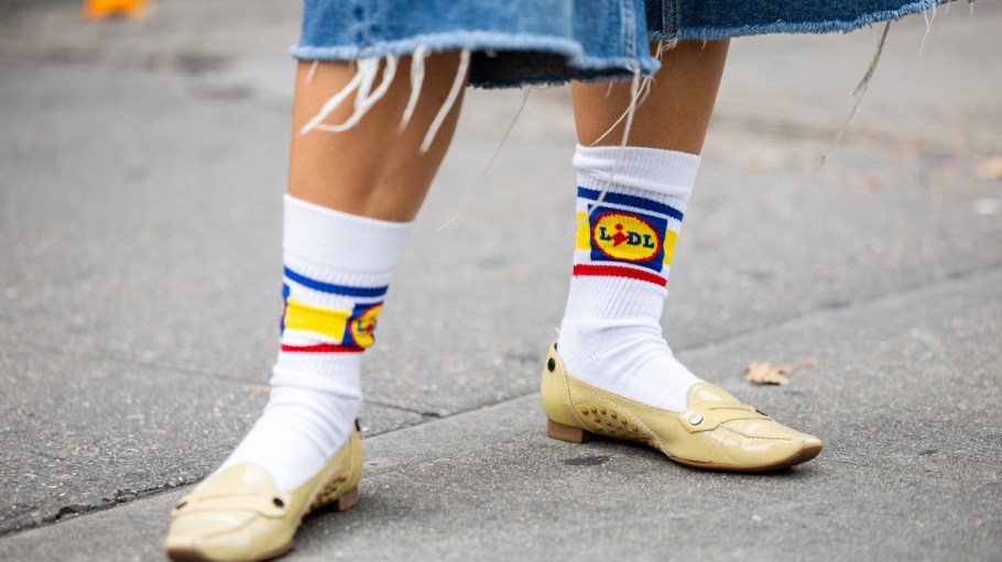 NEW YORK, NEW YORK - SEPTEMBER 13: A guest wears Lidl socks outside Puppets and Puppets on September 13, 2023 in New York City.