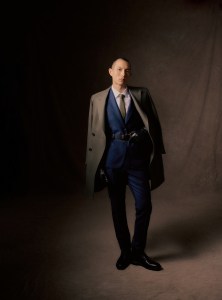 Heritage Gold organic wool coat; Calvin Klein wool and silk suit; Boss cotton and elastane shirt; Barbour gloves and belt; Robert Talbott tie; Geox boots.