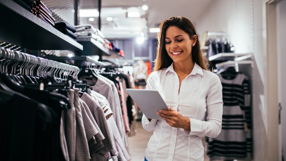 Beautiful woman using tablet while working in the store.