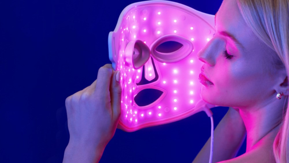 woman using a blue light therapy face mask