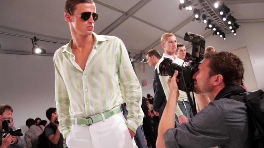 Photographer taking images of model at Perry Ellis runway show.