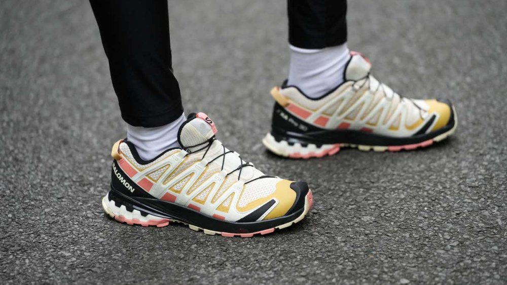 PARIS, FRANCE - APRIL 17: Emy Venturini wears black legging pants from Calzedonia, beige / yellow / black pattern leather sneakers from Salomon, white socks, during a street style fashion photo session,  on April 17, 2023 in Paris, France. (Photo by Edward Berthelot/Getty Images)