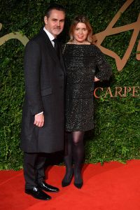 British fashion designer Jenny Packham (R) and husband Matthew Anderson (L) pose on the red carpet as they arrive for the British Fashion Awards in London on December 2, 2013. AFP PHOTO / BEN STANSALL        (Photo credit should read BEN STANSALL/AFP via Getty Images)