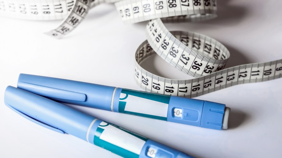 Weight-loss drug injection pens next to a tape measure.