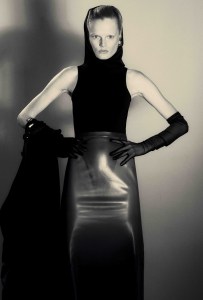 Alaïa wool coat, polyester and viscose bodysuit and latex skirt; Khaite earrings; stylist’s own gloves.