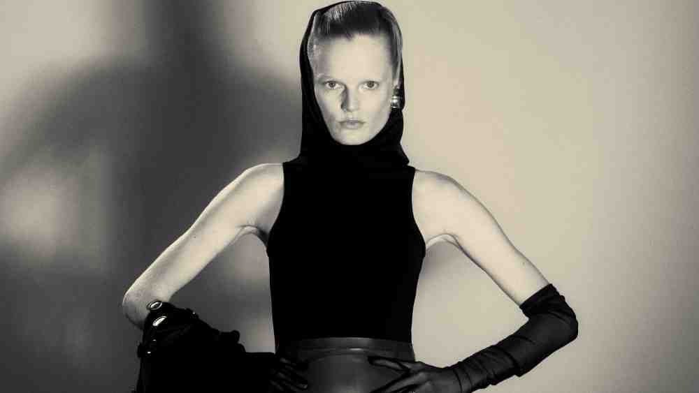 Alaïa wool coat, polyester and viscose bodysuit and latex skirt; Khaite earrings; stylist’s own gloves.