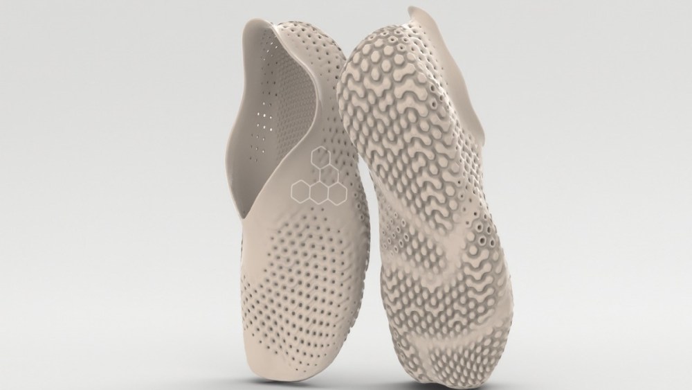 A pair of tan, biodegradable shoes by Vivobarefoot and Balena.