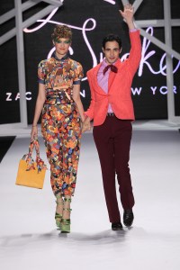Model Madisyn Ritland (L) and designer Zac Posen on the runway after his Z Spoke spring 2011 show at Lincoln Center's Theatre.