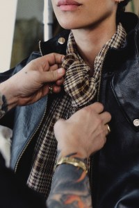 A lambskin Hustler jacket, cotton plaid blouse, Badboy jeans and custom earrings created with Chrishabana.