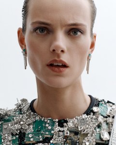 Schiaparelli haute couture Robot dress with exaggerated rounded shoulders entirely embroidered with Swarovski crystal jewels and electronic chips in silver and green; Louis Vuitton Spirit high jewelry Liberty earrings in platinum and 18-karat white gold with emeralds and diamonds.