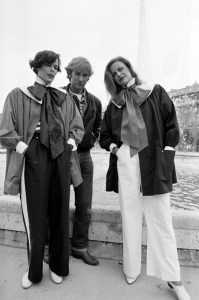 Designer Claude Montana poses with models.