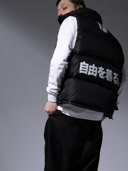 model in black puffer vest