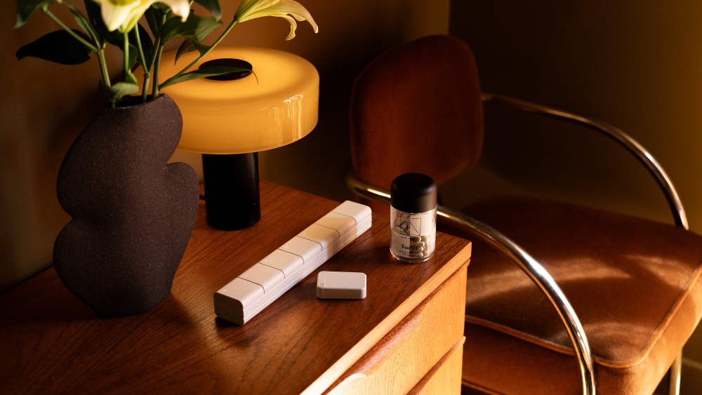 And Repeat products layed out on a wooden side table.